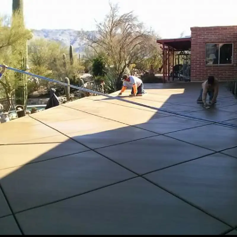 Broom-finished backyard patio with desert views
